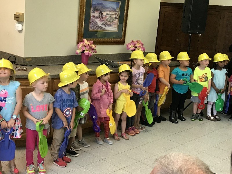 A group of small kids from preschool class assisting in groundbreaking ceremony