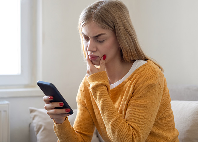 woman looking at mobile phone