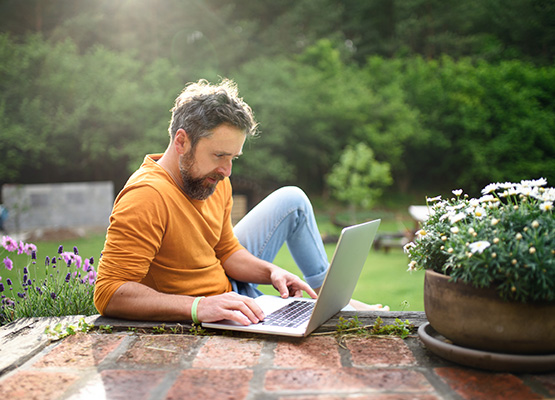 person outdoors with a laptop